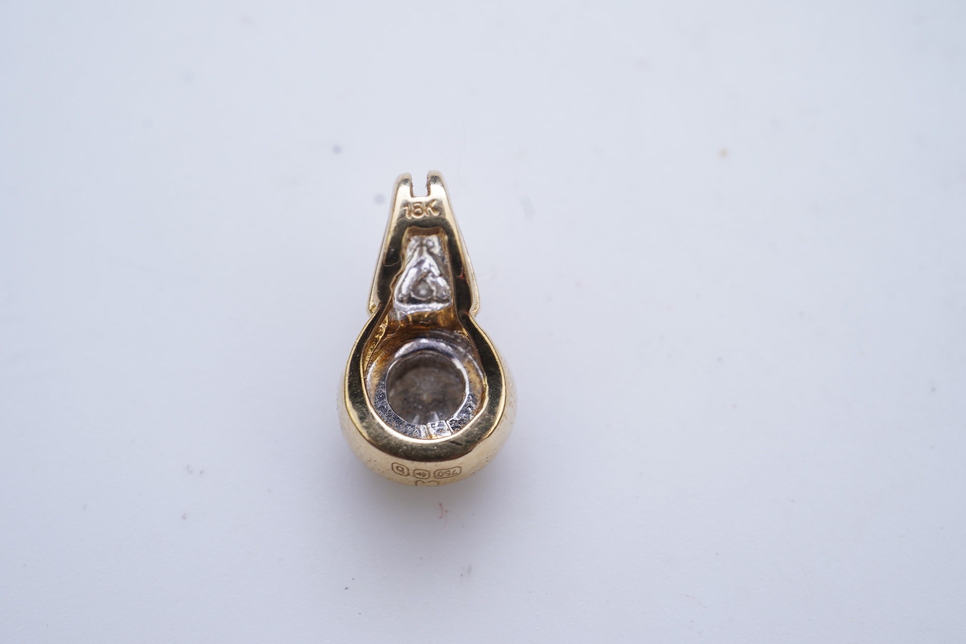 A diamond pendant and pair of diamond stud earrings